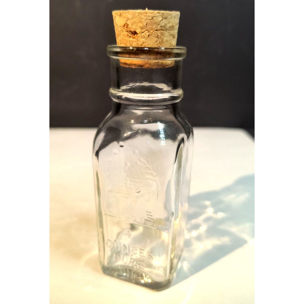 1232.  Corked Glass Honey Jar Embossed Vintage